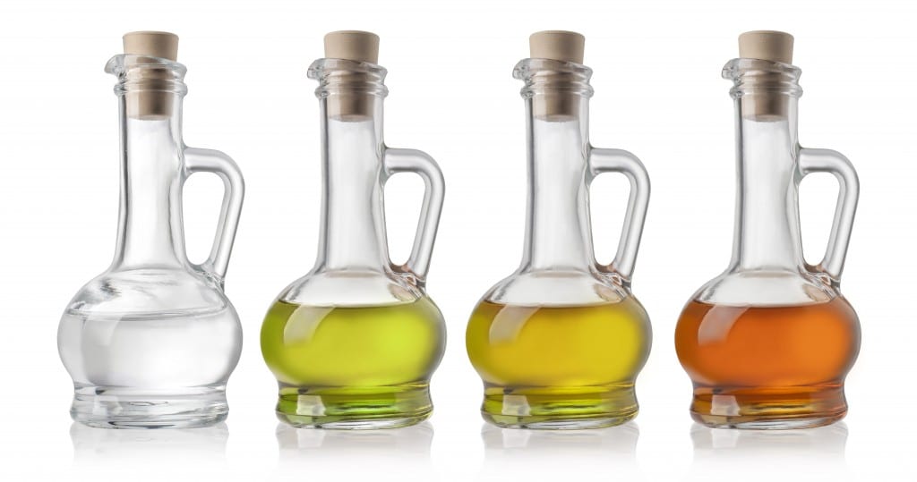 Glass Bottles Of Oil And Vinegar On White Background