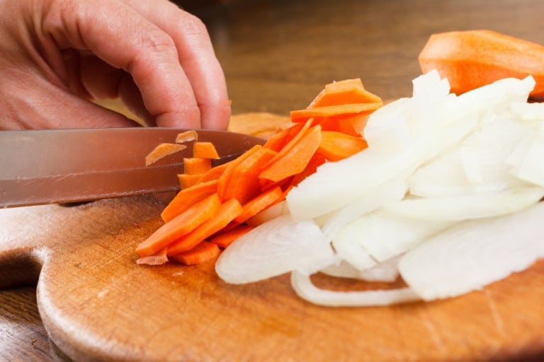 cook cut onion and carrot on chopping board Versatile Vinegar