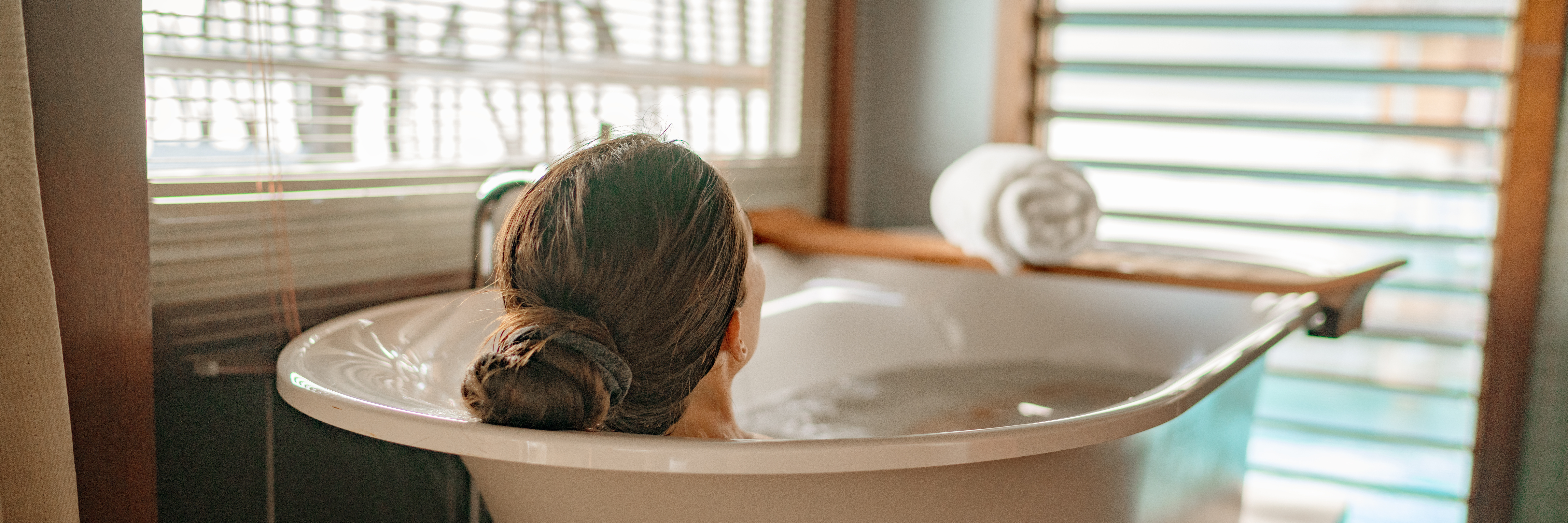 Luxury Bath Woman Relaxing In Hot Bathtub In Hotel Resort Suite Room